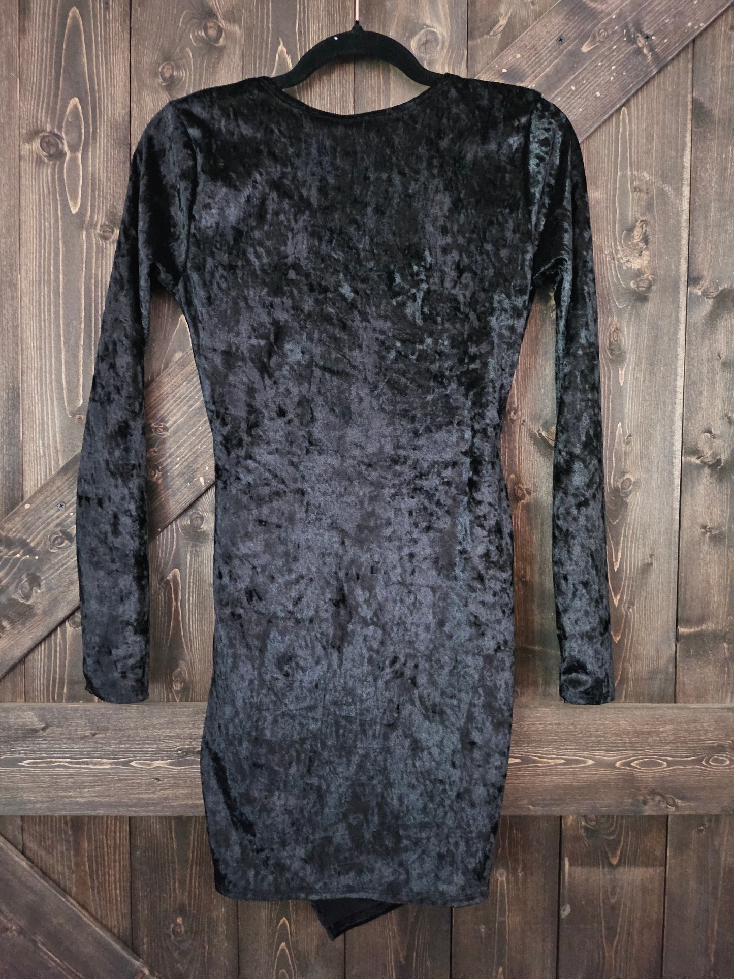 Black velvet body-con wrap dress with long sleeve and v neckline.