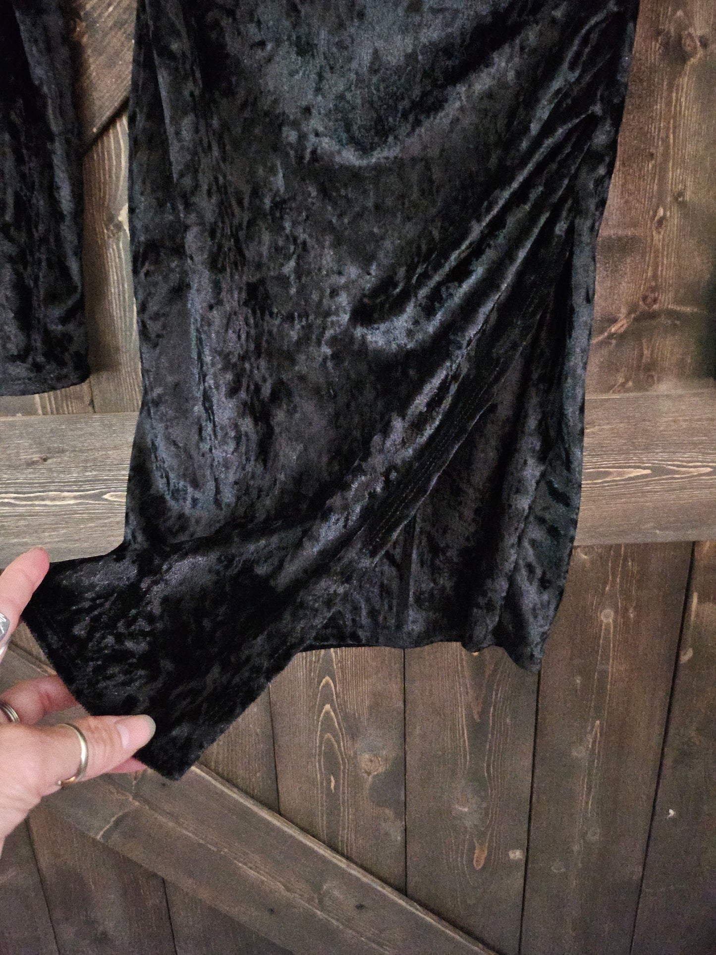 Black velvet body-con wrap dress with long sleeve and v neckline.
